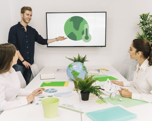 happy-businessman-giving-presentation-global-warming-his-female-colleagues
